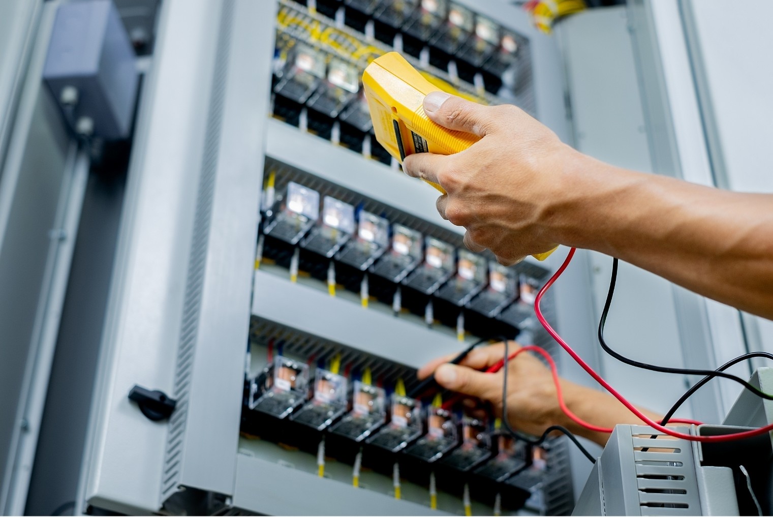 Enginia Energie technician performing preventative maintenance on industrial equipment.