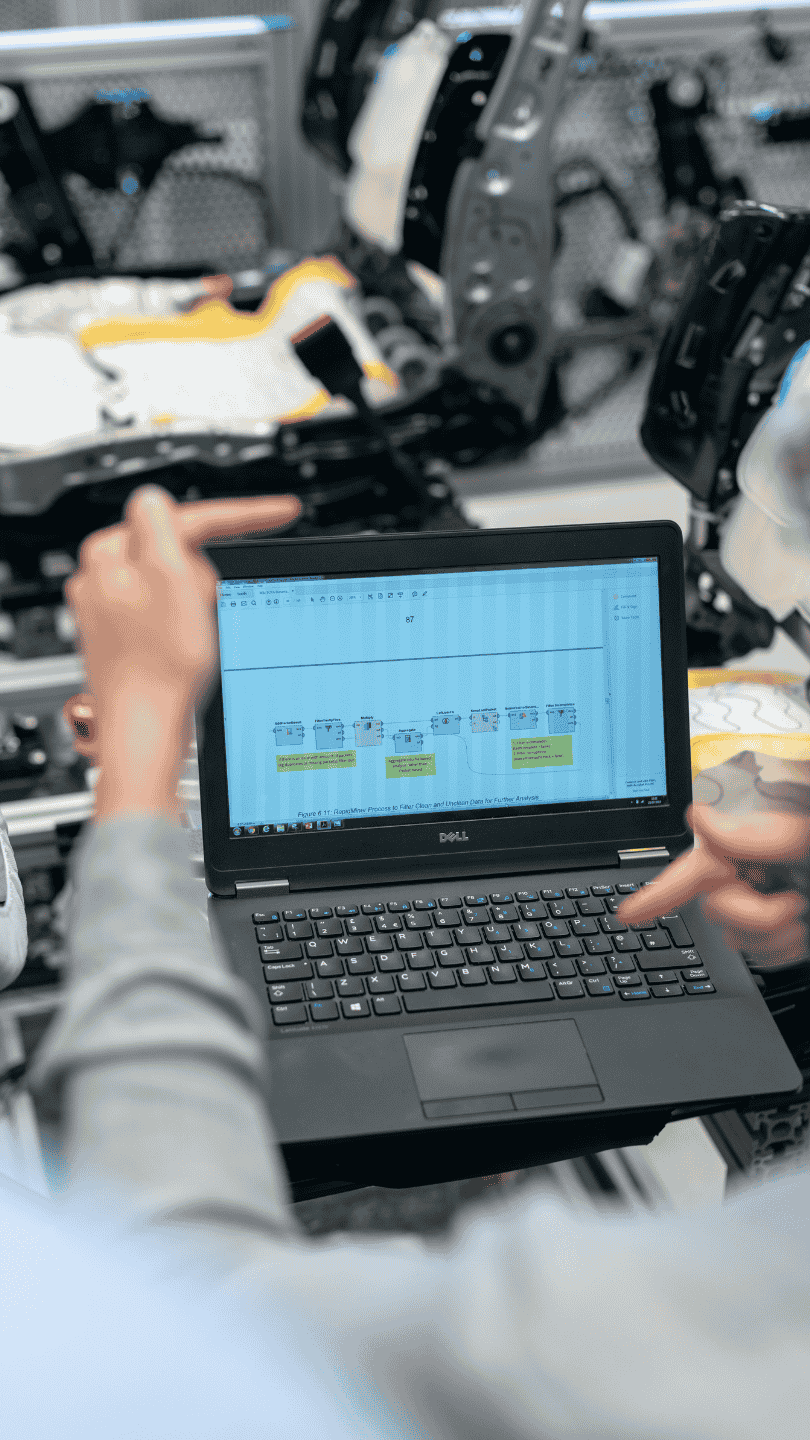 An Enginia Energie engineer designing a SCADA HMI interface on a computer for a water treatment plant's remote monitoring system.
